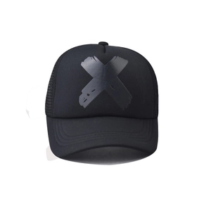 Close-up front view of a black mesh trucker hat featuring a large matte black X graphic
