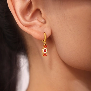 Chic gold hoop earrings featuring a candy pendant with red garnet gemstone detail
