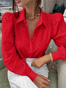 Detailed view of hollow-out embroidery and bubble sleeves on a red casual cardigan top