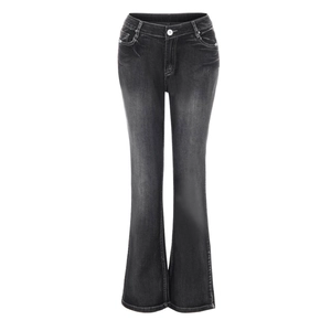 Detail of high-waist flared jeans featuring stone-wash texture and classic metal button