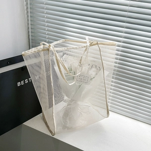 Minimalist white mesh tote bag for beach or shopping shown in bright natural light