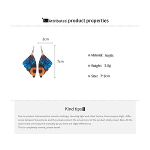 Detail view of acrylic butterfly wing earrings with size 7x3cm and 5.8g weight specs
