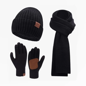 Close-up of black knitted winter set showing beanie, scarf, and touchscreen gloves detail