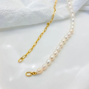 Detailed close-up of mixed freshwater pearl and golden paperclip chain necklace