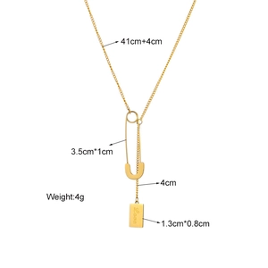 Gold chain necklace featuring paperclip pendant and engraved Love tag on white background