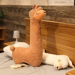 Detail of plush alpaca long pillow in textured teddy fleece on a cozy bed setup