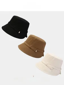 Detail showing foldable cotton fisherman hats in black, coffee, and beige with metal buckles