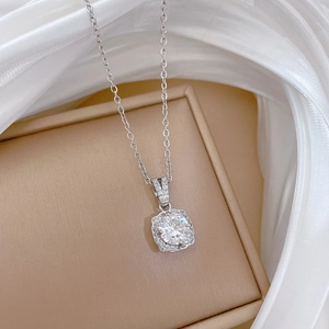 Square pendant necklace with round zircon on white silk background for women
