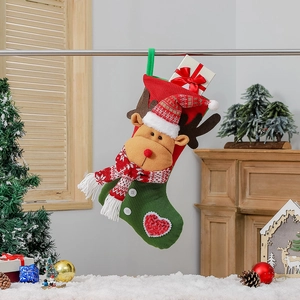 Large Nordic Christmas stocking with 3D reindeer decor hanging by a fireplace