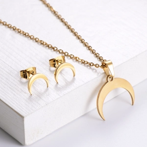 Elegant gold crescent moon jewelry set with matching pendant necklace and stud earrings