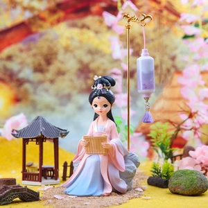 Macro shot of ancient style girl figurine in pink and blue Hanfu reading with purple lantern