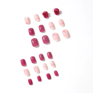 Set unghie finte sfumate rosa con polvere glitterata e decorazioni fiocco rosso 3D