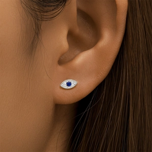 Macro shot of S925 silver marquise crown ear stud with blue gemstone and diamonds on ear