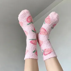 Pink coral fleece crew socks with strawberry pattern for winter warmth and home comfort
