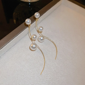French vintage style curved gold tassel earrings adorned with multiple white pearls