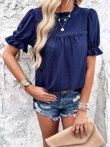 Close-up of navy blue short sleeve top featuring hollow-out lace texture and puff sleeves