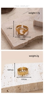 Detailed size and weight specs for gold-toned horseshoe and vine rings on stone