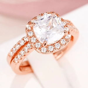 Macro shot of cushion-cut halo zircon rings in rose gold finish with pavé settings