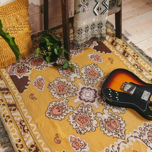 Detail of bohemian woven blanket with vintage floral jacquard pattern and fringe edges