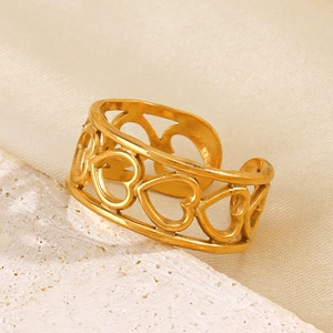 Minimalist gold hollow heart open ring on white stone and beige silk background