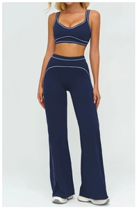 Détail de la bordure blanche sur un ensemble de yoga bleu marine avec pantalon évasé