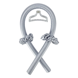 Detail view of silver satin heatless curling rod set with matching scrunchies and hair clip