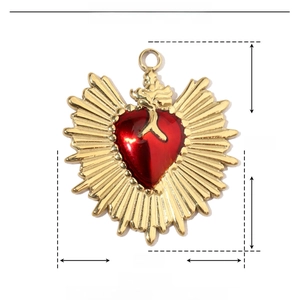 Detailed view of heart-shaped stainless steel pendant with red enamel and golden rays