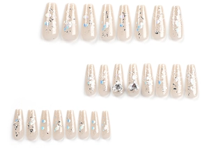 Macro view of long coffin nails with glitter gradients and 3D heart diamond accents