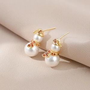 Detail of Christmas snowman pearl earrings with gold scarf and red stone inlay