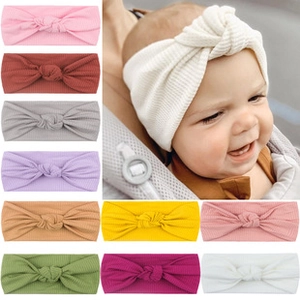 Detail of ribbed knit baby turban hats showing texture and various pastel colors