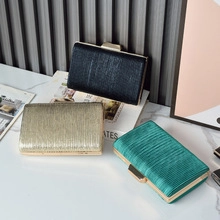 Detailed view of elegant pleated evening clutch bags in black, gold, and green variants