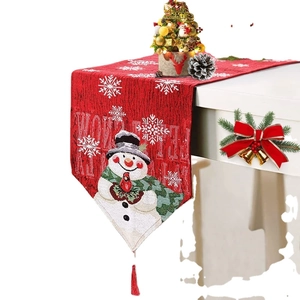 Christmas snowman table runner with snowflake embroidery and red tassels on table corner