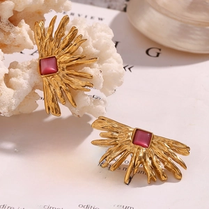 Detail of 18K gold plated starfish earring with seashell inlay and red gemstone