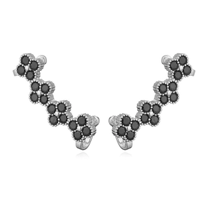 Detailed view of silver ear climbers with four-petal black zircon floral vine design