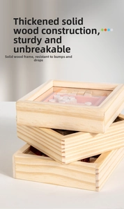 Close-up of three stacked wooden maze toys with clear acrylic covers and colorful parts