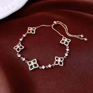 Elegant gold-plated bracelet with clover-style zircon flowers on luxury red velvet
