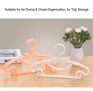 Close-up of bow-tie plastic hangers for babies, featuring non-slip notched design.