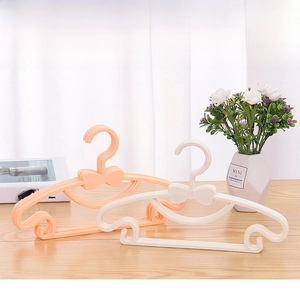 Close-up of bow-tie plastic hangers for babies, featuring non-slip notched design.