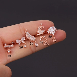 Macro detail of rose gold butterfly and feather rings set with sparkling zircons