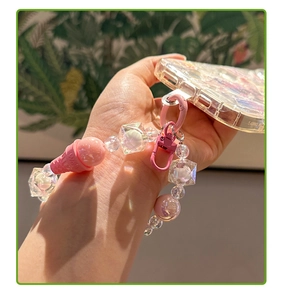 Detail of sweet beaded phone strap with pink ice cream charm and metal clasp