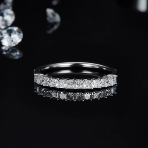 Macro view of princess-cut moissanite stones set in a sterling silver eternity ring