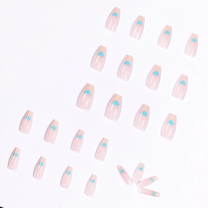 Long coffin false nails in nude pink with light blue heart designs and glossy finish