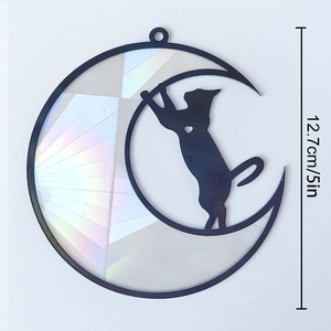 Detail of 5-inch rainbow suncatcher showing a black cat on moon with holographic finish