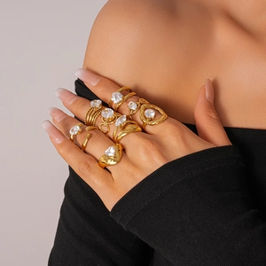 Detailed view of layered gold zircon rings with irregular and heart-shaped designs