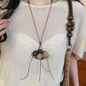 Detailed shot of ethnic vintage pendant necklace with natural stones and wooden beads