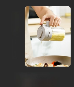 300ml glass spice jar with grey lid showing functional pouring action into a frying pan