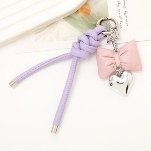 Close-up of lavender braided rope keychain with pink bow and silver heart pendant