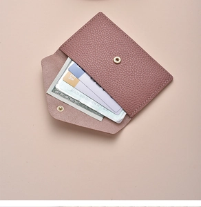 Detailed macro view of pink pebbled leather wallet interior with functional card slots