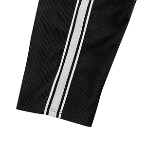 Detailed close-up of black corduroy fabric with white side stripes and ribbed texture