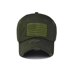 Detailed view of dark olive washed cotton baseball cap with distressed USA flag patch